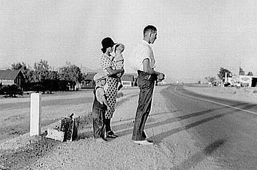 Great Depression: Oklahoma farm family on highway between Blythe and Indio. Forced by the drought of 1936 to abandon their farm, they set out with their children to drive to California. Picking cotton in Arizona for a day or two at a time gave them enough for food and gas to continue. On this day, they were within a day's travel of their destination, Bakersfield, California. Their car had broken down en route and was abandoned. Photo by Dorothea Lange. Courtesy Library of Congress, Prints & Photographs Division, FSA-OWI Collection LC-USF34- 009680-C