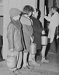 Great Depression: Children waiting in line for soup given out each night by the city mission, a community chest- financed organization. Dubuque, Iowa. Photo by John Vachon. Courtesy Library of Congress, Prints & Photographs Division, FSA-OWI Collection LC-USF34- 060600-D